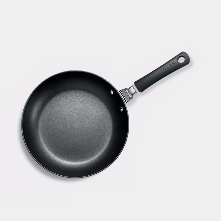 Close up of new frying pan with removable handle. Action. Concept